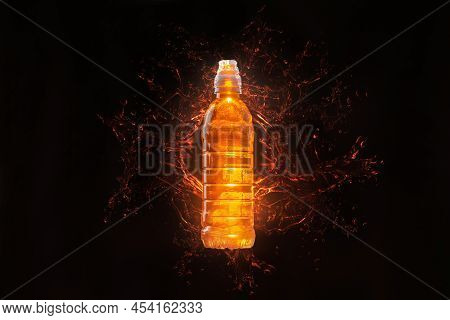 Isotonic Energy Drink. Orange Bottle On Black Background With Splashes Of Orange Liquid