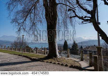 Lucerne, Switzerland, March 10, 2022 Lovely Green Park At The Musegg Walls On A Sunny Day