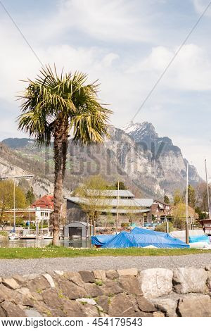 Weesen, Switzerland, April 13, 2022 Lovely Little Park At The Coast Of The Lake Walensee In Spring T