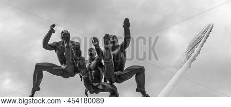 Minsk, Belarus - April 29, 2022: Sculpture Running With Men Runners Monument On Dramatic Sky Backgro