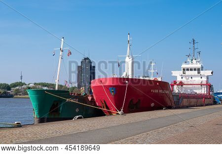 Rotterdam, Netherlands - April 28, 2022: Green Cargo Ship Athos And Red Feed Helgeland In The Port O