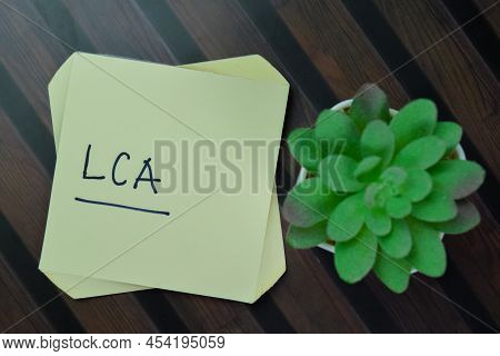 Lca - Life-cycle Assessment Write On Sticky Notes Isolated On Wooden Table.
