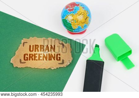 Ecological And Industrial Concept. On The Table Is A Globe And A Marker, On A Green Background There