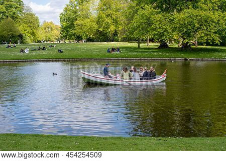 Frederiksberg, Denmark - May 07, 2022: People In A Rowboat In Frederiksberg Gardens.