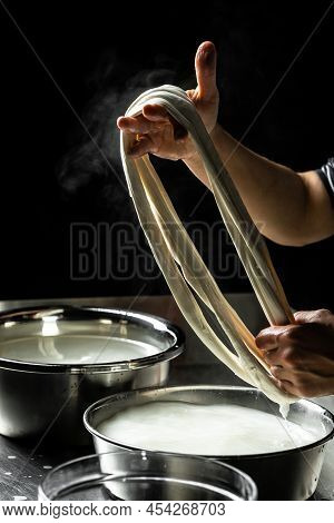 Cheesemaker Showing The Proceeding To Make Cheese From The Bio Milk. The Homemade Cheese Maker Produ
