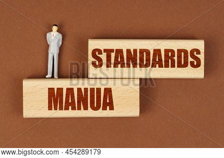 Business Concept. On A Brown Surface On Wooden Blocks With The Inscription - Standards Manua, There 