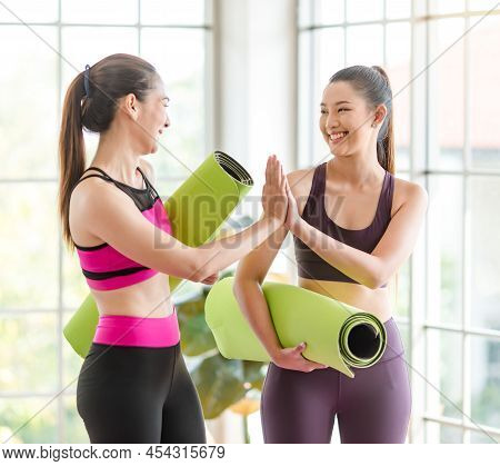 Two Asian Young Healthy Slim Beautiful Female Sporty Models In Sexy Crop Top Sportswear Standing Smi
