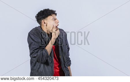 Amazed Young Man With Hand Near Open Mouth, Man Looking Aside With Face Scared Expression, Surprised
