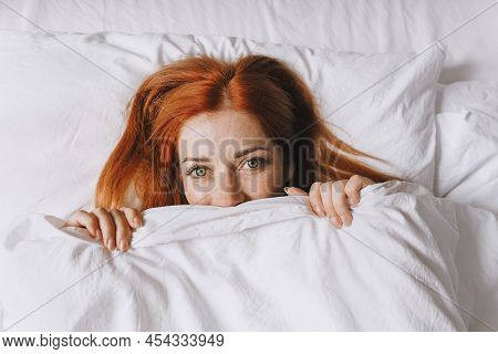 Shy Young Woman Hiding Under Bed Cover Acting Coyly