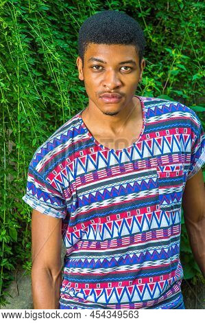 Portrait Of Young Black Man. Wearing A Short Sleeve, Collarless, Colorful Pattern Shirt, A Young Han