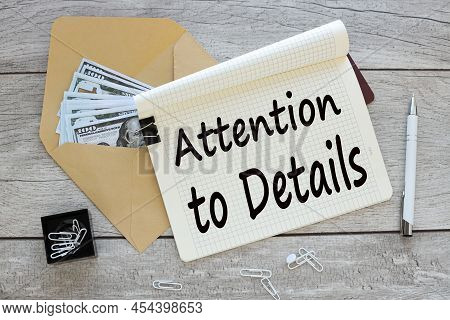 Attention To Detail Text On A Notepad Page. Glasses On The Work Table