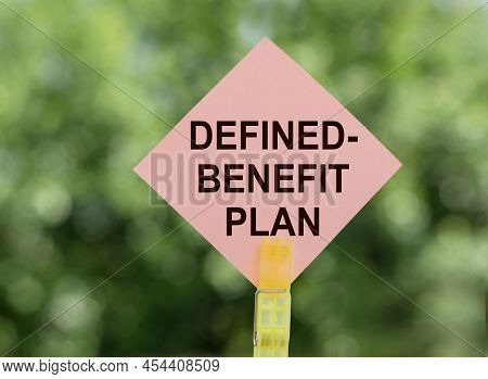 Defined-benefit Plan - Inscription On Pink Road Sign On Blurred Green Background.