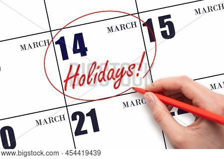 14th Day Of March. Hand Drawing A Red Circle And Writing The Text Holidays On The Calendar Date 14 M