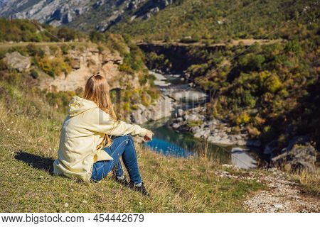 Montenegro. Woman Tourist On The Background Of Clean Clear Turquoise Water Of River Moraca In Green 