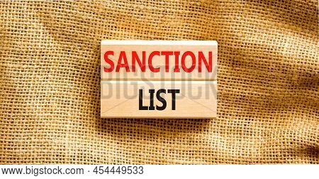 Sanction List Symbol. Wooden Blocks With Concept Words Sanction List On Beautiful Canvas Background.