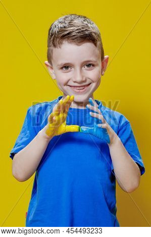 Little Happy Boy With Painted Palms In Yellow And Blue, The Colors Of The Flag Of Ukraine. Ukrainian