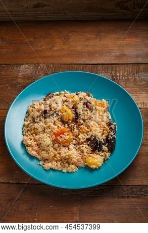 Cous Cous On Honey With Dried Fruits, Saffron And Boiled Nuts In A Plate. Vertical Photo