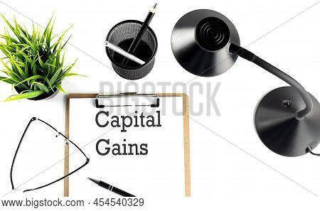 Capital Gains Text On Clipboard On The White Background