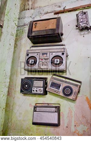A Collection Of Old Radios And Tape Recorders. Retro Outdated Portable Stereo Boombox Radio Receiver