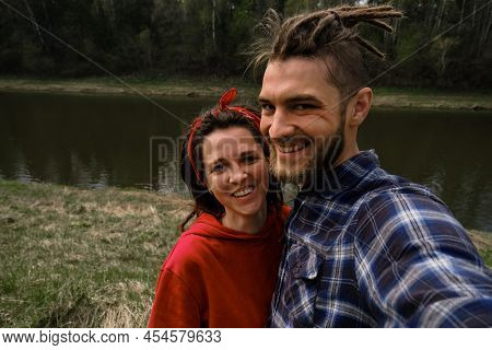 Concept Of Support And Family Values. Young European Couple, Man And Woman With Dreadlocks Hug And T