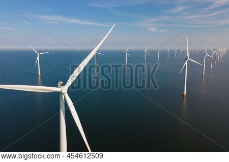 Offshore Windmill Farm In The Ocean Westermeerwind Park, Windmills Isolated At Sea On A Beautiful Br