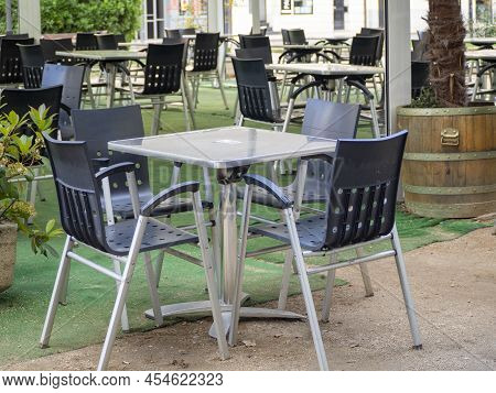 Empty Chairs And Tables At Closed Outdoor Restaurant For The Inflation Crisis.