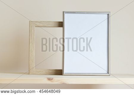 Simple Composition With Two Frames Silver And Wooden Frames On Yellow Background.