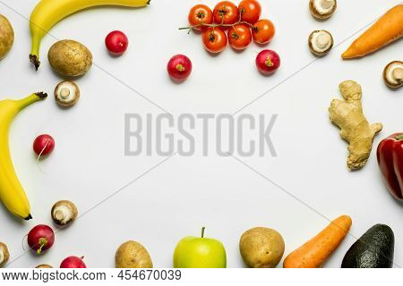 Top View Of Frame From Ripe Fruits And Vegetables On White Background.