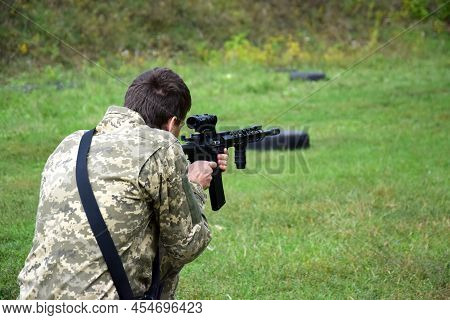 Kharkiv, Ukraine - September 4, 2021: A Young Guy Is Trained In Combat Shooting From A Rifle Ar 15. 