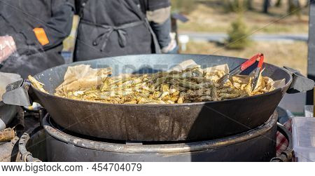 Smelt Fish Is Fried On A Large Grill During The Fish Festival In Svetlogorsk Raushen, Region, Russia