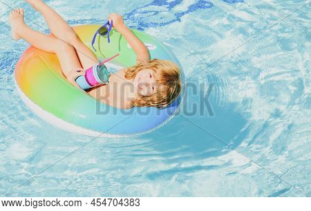 Portrait Of A Kid Laughing In A Swimming Pool. Cocktail On Watter Pool In The Summer.