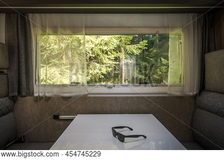 Scenic Summer Time Spruce Woodland View From Rv Camper Van Dinette Window. Vacation Motorhome Getawa