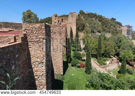 Malaga, Spain, May 8, 2022: Walls Of The Alcazaba Of Malaga. Palatial Fortification From The Islamic