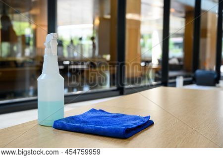 Cleaner Disinfectant Spray Bottle With Blue Microfiber Cloth On Table. Cleaning Products For Disinfe