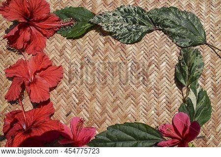 Beautiful Background Of Red Bright Hibiscus Flowers On Wicker Bamboo Background.floral Backdrop Wall