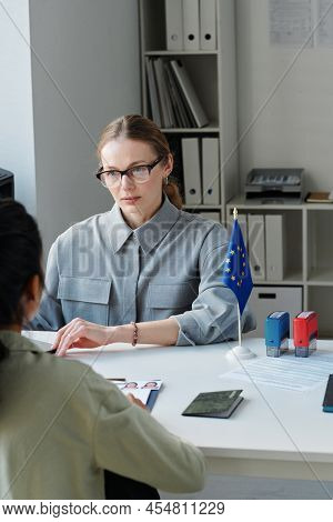 Vertical Shot Of Unrecognizable Woman Applying For Travel Visa Having Appointment In Embassy