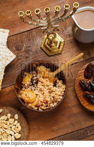 A Plate Of Couscous With Saffron And Nuts On A Wooden Table Nearby And A Jug Of Fruit Broth. Vertica