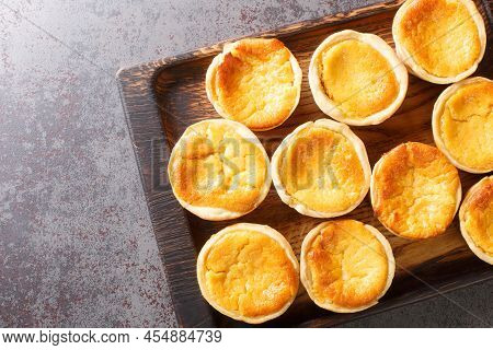 Queijadas De Sintra Are Sweet Cheese Tarts With A Hint Of Cinnamon Close-up On A Wooden Tray On The 