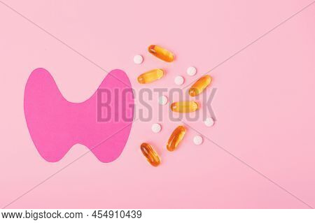 Top View Of Paper Thyroid Gland With Gelatin Capsules And Tablets.world Thyroid Day Concept.