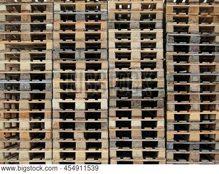 Background Of Hundreds Of Wooden Pallets In The Warehouse Of The Freight Forwarder Without People