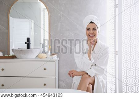 Beautiful Young Woman Wearing Soft White Robe In Bathroom