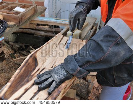 Scraping A Niche In A Burnt Wooden Material In The Process Of Making A Handicraft Tray For Panning G