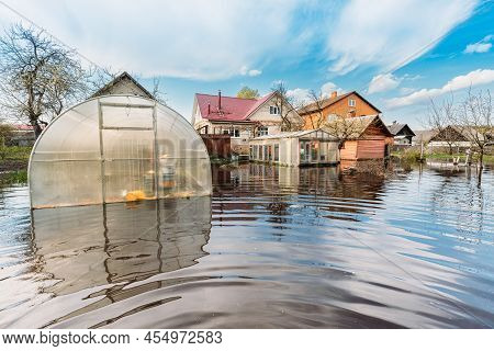 Vegetable Garden Beds In Water During Spring Flood Floodwaters During Natural Disaster. Greenhouse H