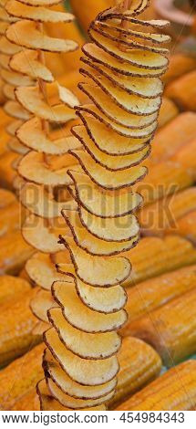 Long Skewers Of Fried Potato Chips With Peel And Yellow Organic Corn Cobs  For Sale In Street Food S