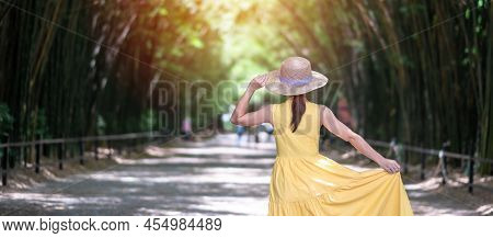 Asian Woman In Yellow Dress And Hat Traveling At Green Bamboo Tunnel, Happy Traveler Walking Chulabh