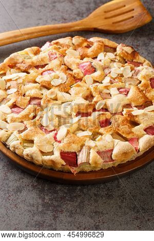 Delicious Homemade Rhubarb Pie With Almonds Close-up In A Dish On The Table. Vertical