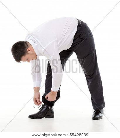 Man Bending Down To Do Up His Shoelaces
