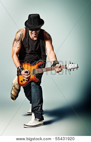 Rock musician is playing electrical guitar.