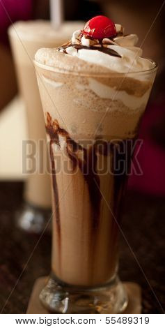 Cold coffee with cream and a cherry on top.