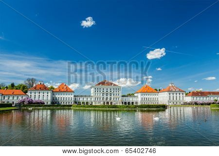MUNICH, GERMANY - MAY 8, 2012: Swans in artificial pool in front of the Nymphenburg Palace. Munich, Bavaria, Germany
